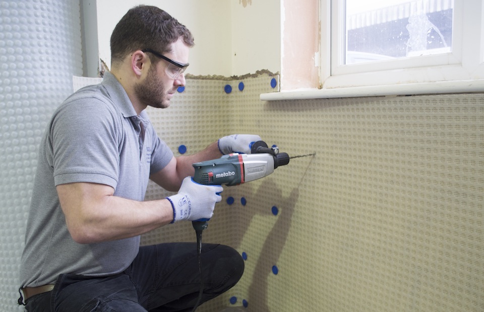 Damp proofing membrane installation on interior walls