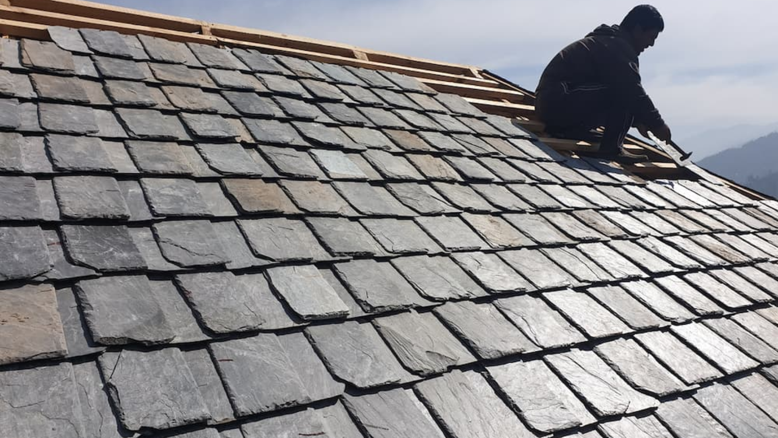 Newly installed natural slate roof tiles showing expert craftsmanship